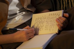 side-view-woman-with-journal-home